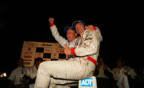 JJ Lehto and Marco Werner celebrate in victory circle