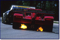 The Risi Ferrari spits flames as van de Poele downshifts for turn 6