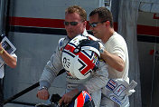 Johnny Herbert and Jamie Davies share a scooter ride in the  paddock at Sebring