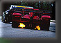 The Risi Ferrari spits flames as van de Poele downshifts for turn 6