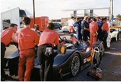 Team Joest mechanics relax as they wait for their new Audis to start the first qualifying session.