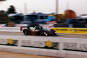 Late afternoon, the blackened flanks of Juan Fangio II's 333 SP s/n 018 flash by on the front straight, running like a train in 3rd place.