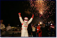 Champion Audi driver Marco Werner stands proud after winning the Chevy presents Petit Le Mans with co-driver JJ Lehto