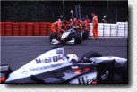 The marshals pushing the car from the track 