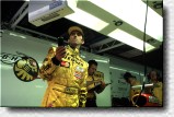 Damon Hill watches the screen in the pits 