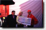 Michael Schumacher gives a cheque about DM 500,000.00 to Ute Ohoven, ambassador of the UNESCO. On the left Dr. Helmut Thoma, boss of the TV station RTL