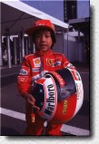 A young Japanese with Schumacher's old helmet. He will wear it when he becomes the first Japanese world champion in 2010. 
