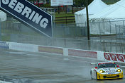 One of the Alex Job Racing Porsches navigates the wet front  stretch in Tuesday's testing