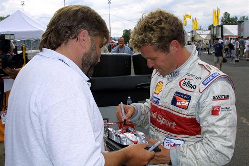 Tom Kristensen signs a model of the Infineon Audi R8