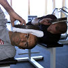 Hold your head up high: Emanuele Pirro (front) and Johnny Herbert working out with weights. In a training specifically for race drivers the focus was on strengthening shoulder and neck muscles
