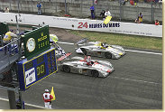 Audi celebrates a 1-2 at Le Mans: Emanuele Pirro in the Infineon Audi R8 (#1) crosses the finishing line ahead of Laurent Aiello (#2)