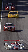Audi R8 with Emanuele Pirro in his slip stream a BMW M3, a Chevy Corvette followed by a Dodge Viper