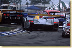 Capello negotiates heavy traffic at turn 3