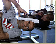 Hold your head up high: Emanuele Pirro (front) and Johnny Herbert working out with weights. In a training specifically for race drivers the focus was on strengthening shoulder and neck muscles