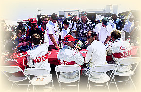Allan McNish signing a shirt, Rinaldo Capello and Emanuele Pirro looking after ...... and a busy Frank Biela